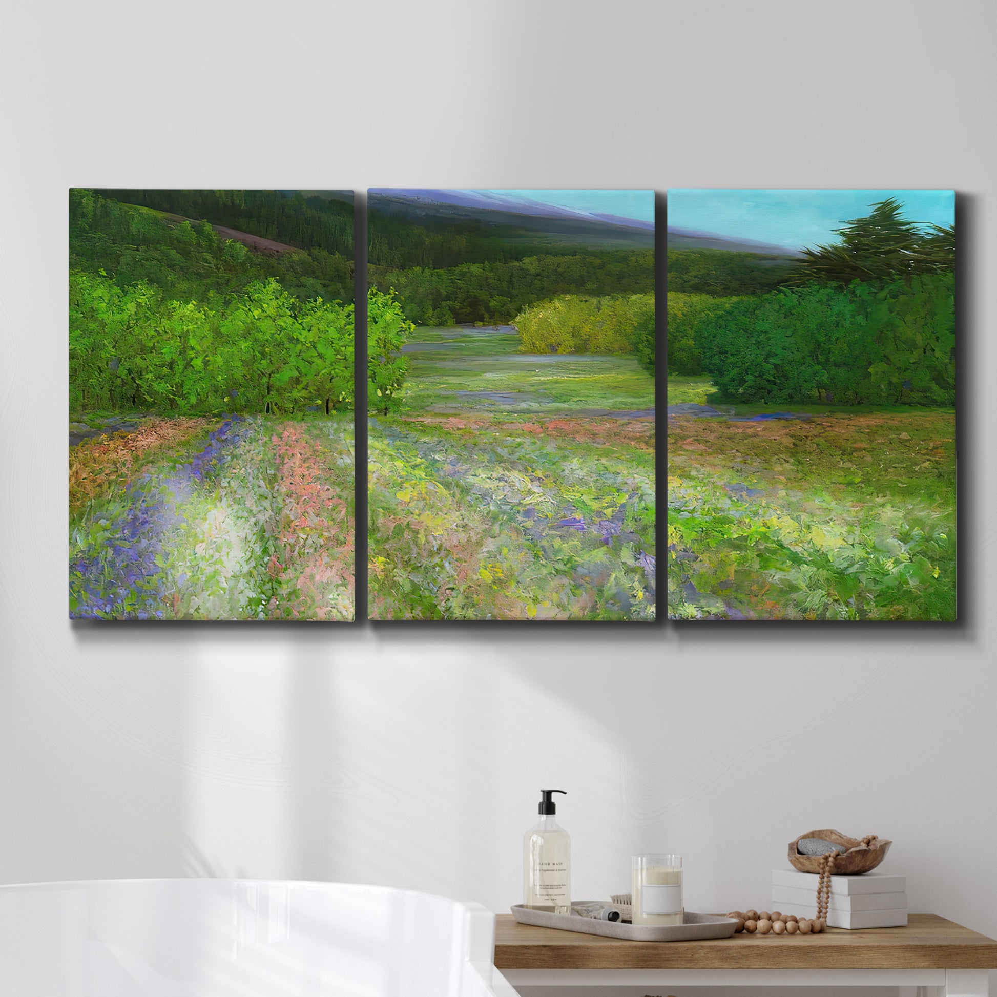 Three-panel canvas wall art featuring fresh spring meadow landscape, displayed in a bathroom above a bathtub.