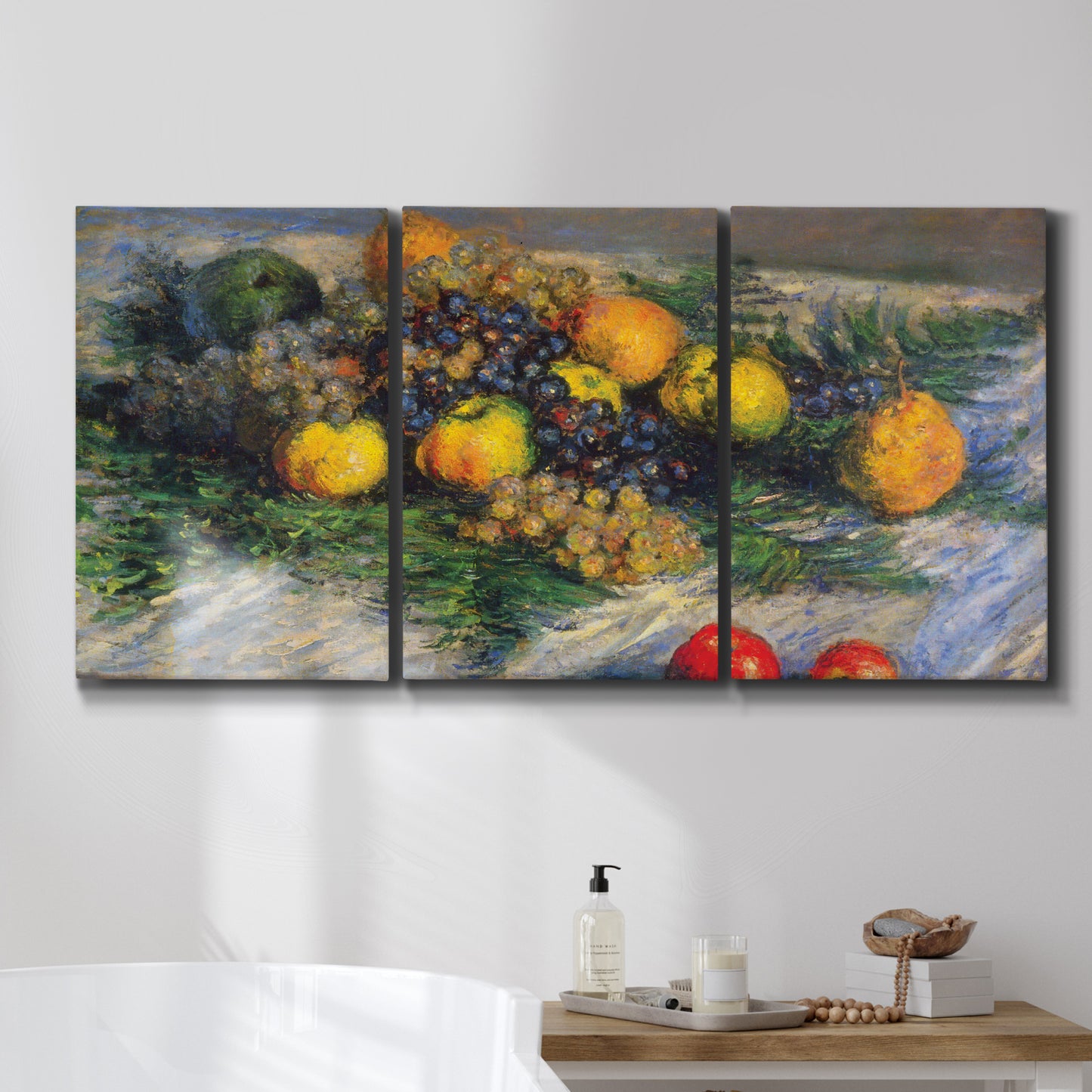 Three-panel canvas wall art featuring still life with pears and grapes, displayed in a bathroom above a bathtub.