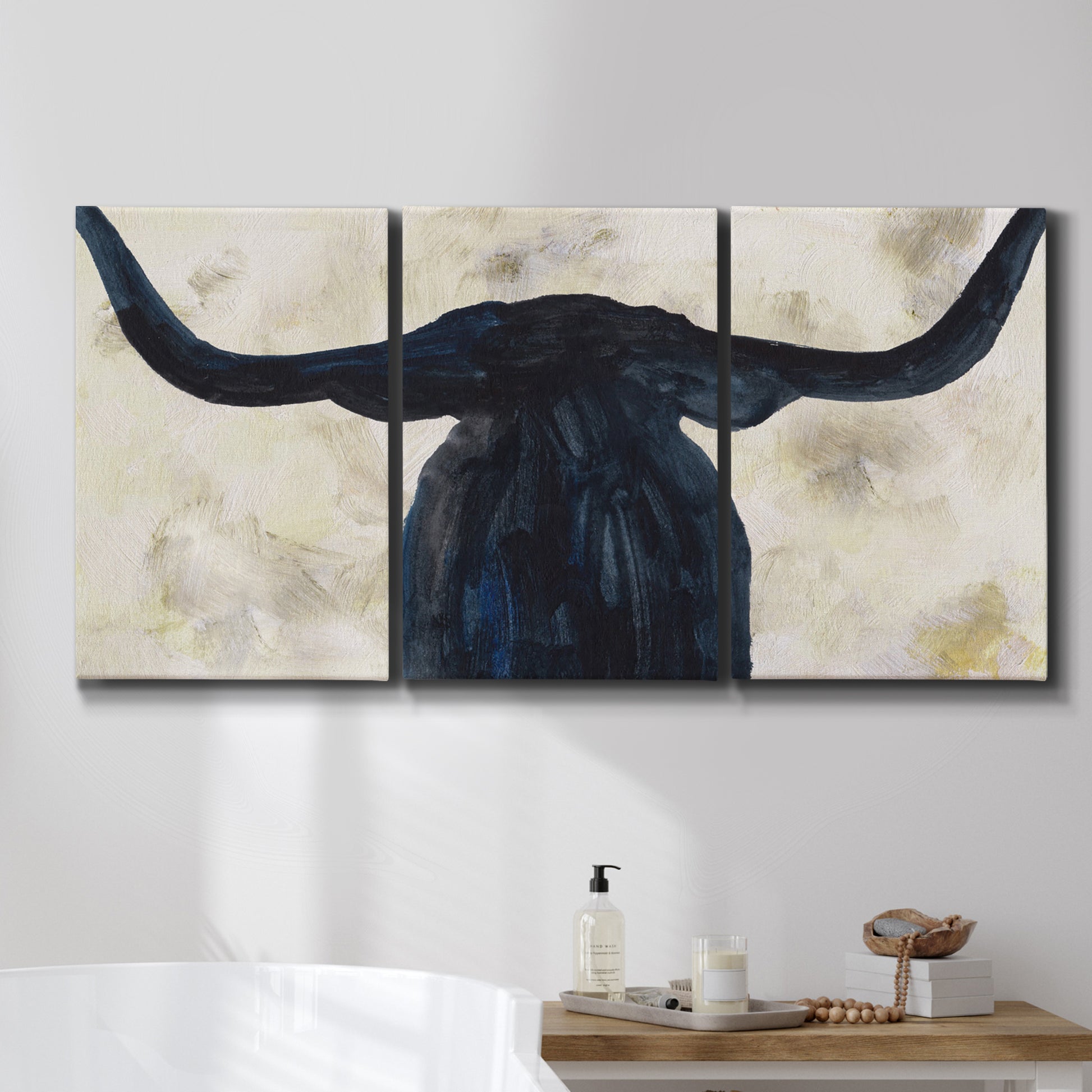Three-panel canvas wall art featuring rustic animal portrait illustration, displayed in a bathroom above a bathtub.