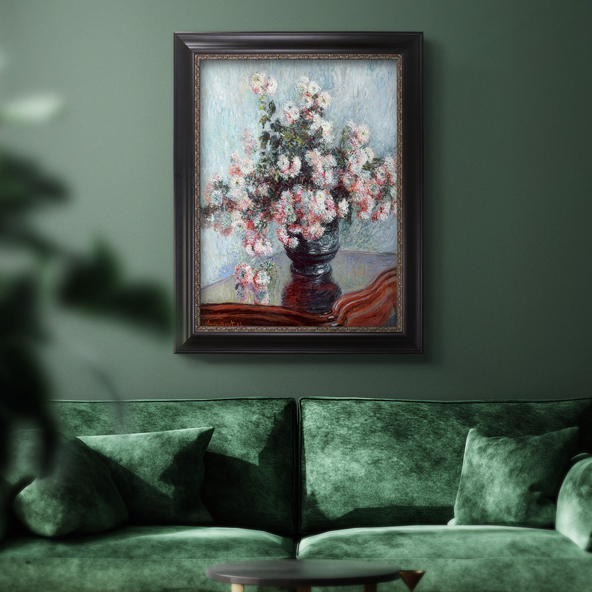 Impressionist chrysanthemum floral painting by Claude Monet in an ornate black frame with gilded inner detail displayed in a dark-toned interior setting.