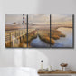Three-panel canvas wall art featuring coastal path along dunes, displayed in a bathroom above a bathtub.