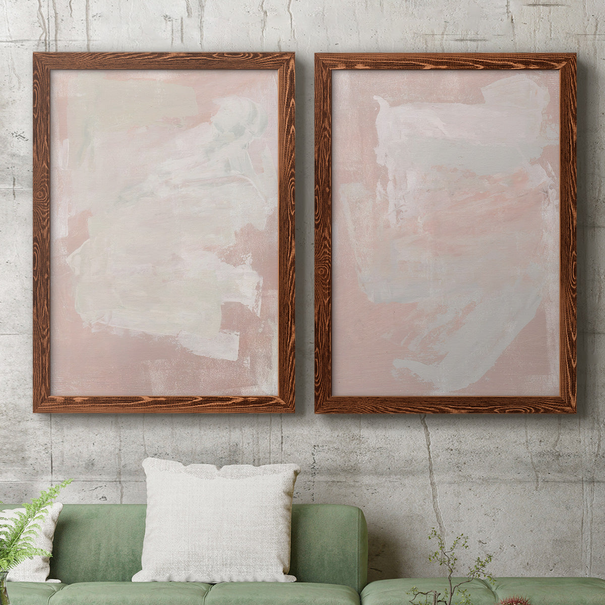 Set of two maple barnwood framed canvas prints depicting a coordinated art pair of soft blush and white painterly fields rendered as minimalist color-field abstracts above a sofa in a modern living room.