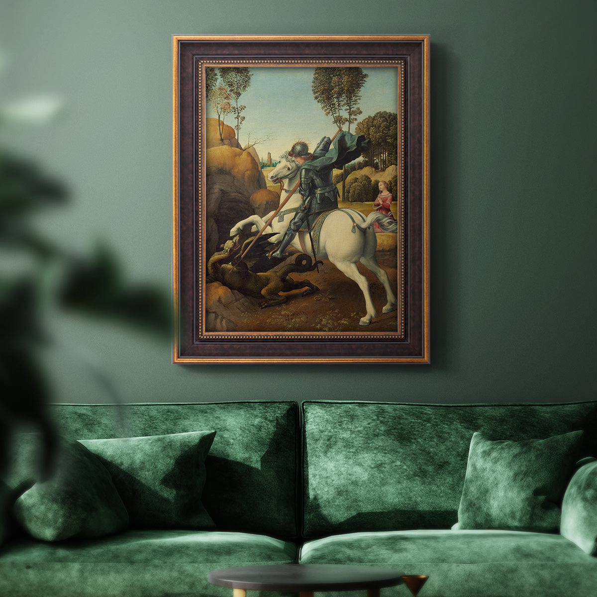 Religious painting of Saint George slaying the dragon by Raphael in an ornate bronzed mahogany wood frame displayed in a dark-toned interior setting.