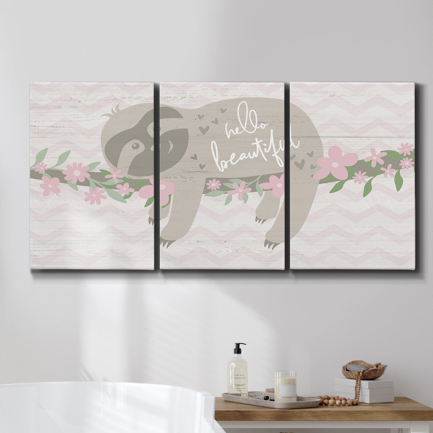 Three-panel canvas wall art featuring sloth with floral decorative elements, displayed in a bathroom above a bathtub.