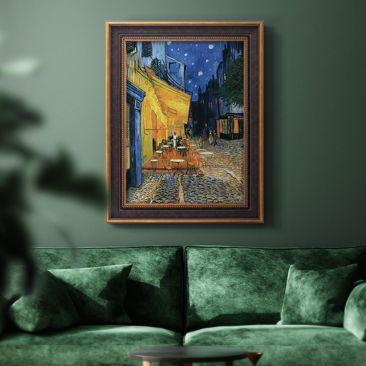 Impressionist night café street scene by Vincent van Gogh in an ornate bronzed mahogany wood frame displayed in a dark-toned interior setting.