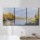 Three-panel canvas wall art featuring river flowing past village, displayed in a bathroom above a bathtub.
