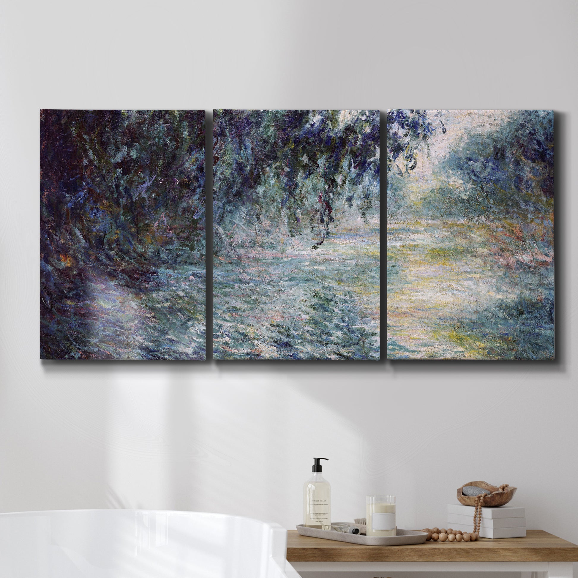 Three-panel canvas wall art featuring misty river scene in morning light, displayed in a bathroom above a bathtub.