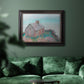 Impressionist coastal building landscape by Claude Monet in an ornate black frame with gilded inner detail displayed in a dark-toned interior setting.