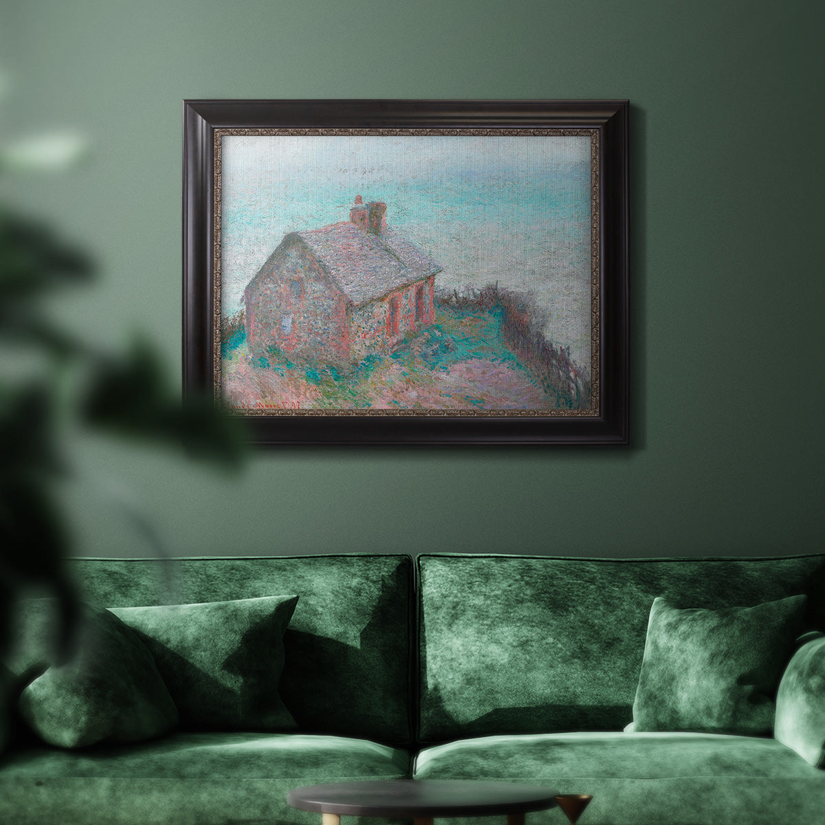 Impressionist coastal building landscape by Claude Monet in an ornate black frame with gilded inner detail displayed in a dark-toned interior setting.