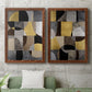 Set of two maple barnwood framed canvas prints depicting a coordinated art pair of interlocking black gray cream and gold geometric sections rendered as structured modern abstracts above a sofa in a modern living room.