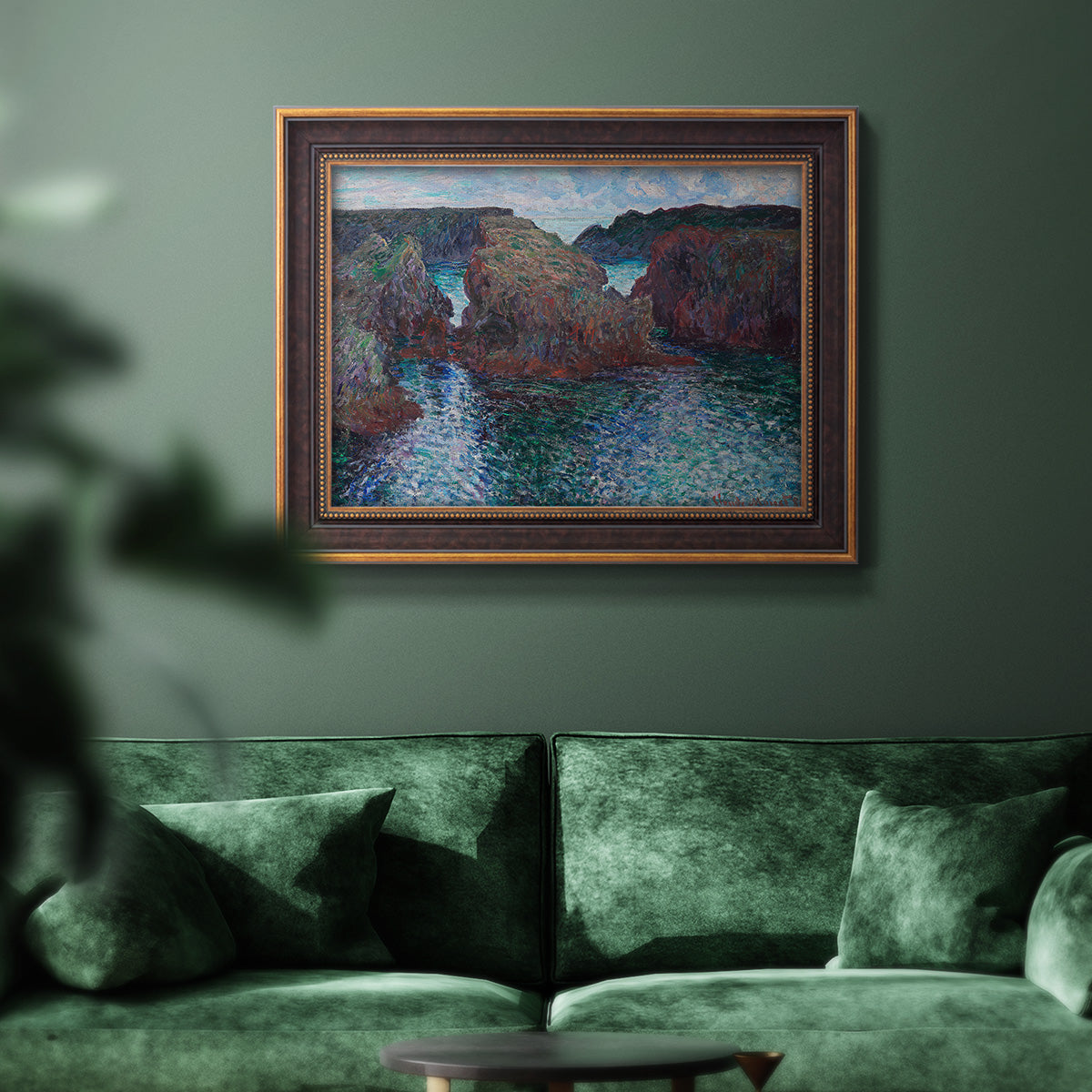 Impressionist rocky seascape by Claude Monet in an ornate bronzed mahogany wood frame displayed in a dark-toned interior setting.