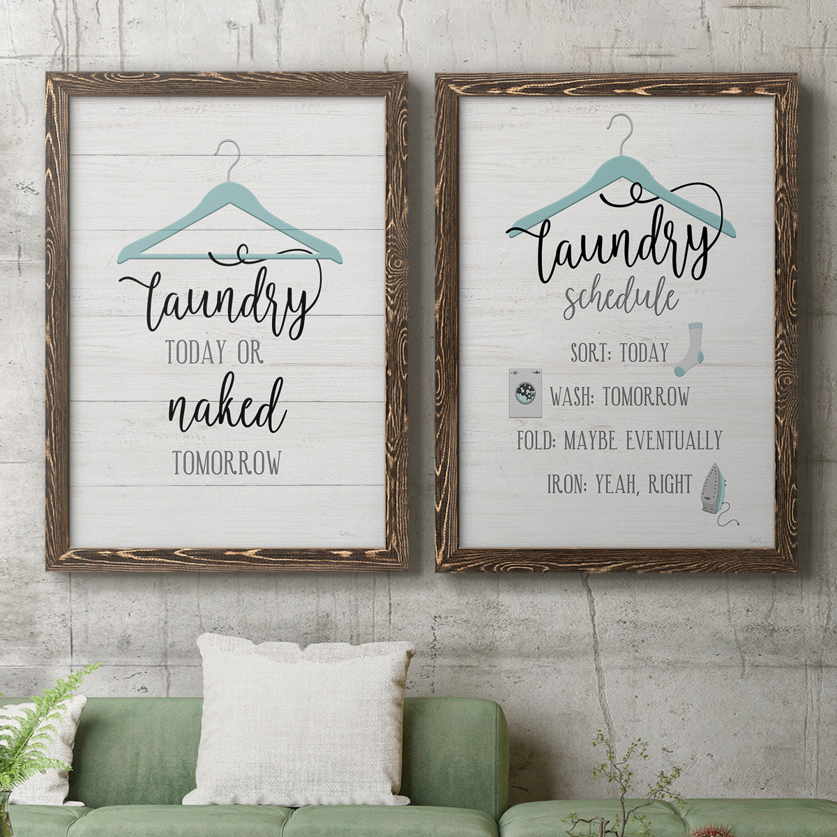 Set of two walnut barnwood framed canvas prints depicting a coordinated art pair of humorous laundry-room sayings and clothing icons rendered as rustic typographic wall art above a sofa in a modern living room.