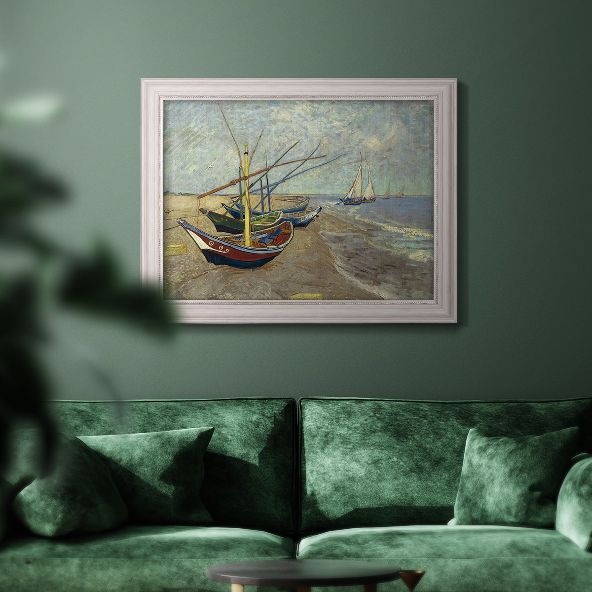 Impressionist coastal fishing boats scene by Vincent van Gogh in an ornate weathered white frame displayed in a dark-toned interior setting.
