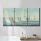 Three-panel canvas wall art featuring sailboats silhouetted at sunrise, displayed in a bathroom above a bathtub.