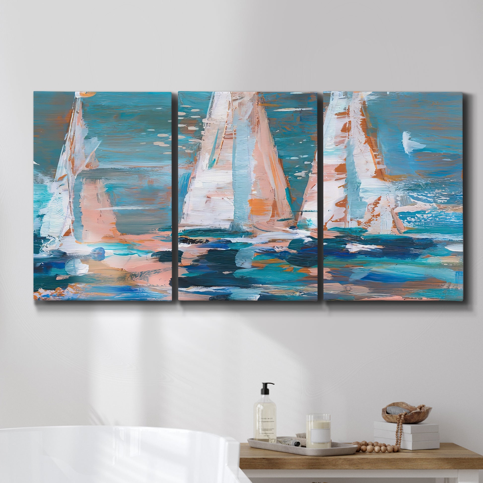 Three-panel canvas wall art featuring graphic pop style sailboats, displayed in a bathroom above a bathtub.