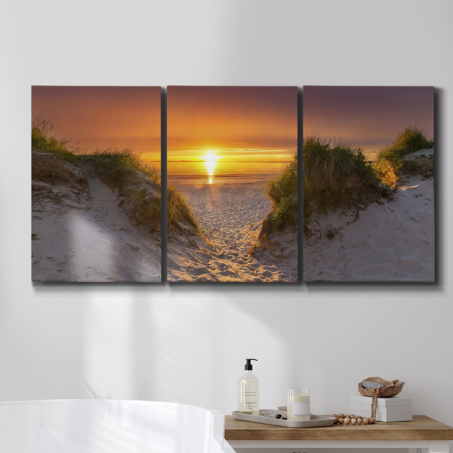 Three-panel canvas wall art featuring sunlit tropical path through greenery, displayed in a bathroom above a bathtub.