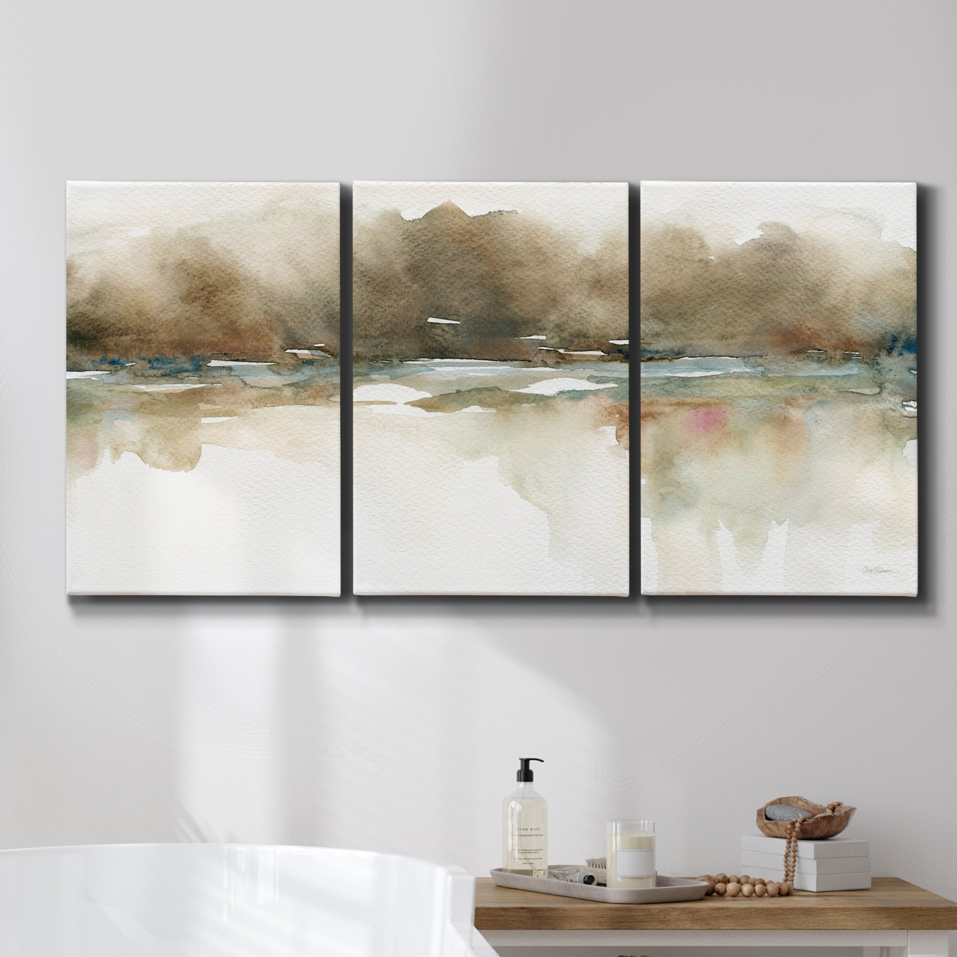 Three-panel canvas wall art featuring soft abstract mirrored reflections, displayed in a bathroom above a bathtub.