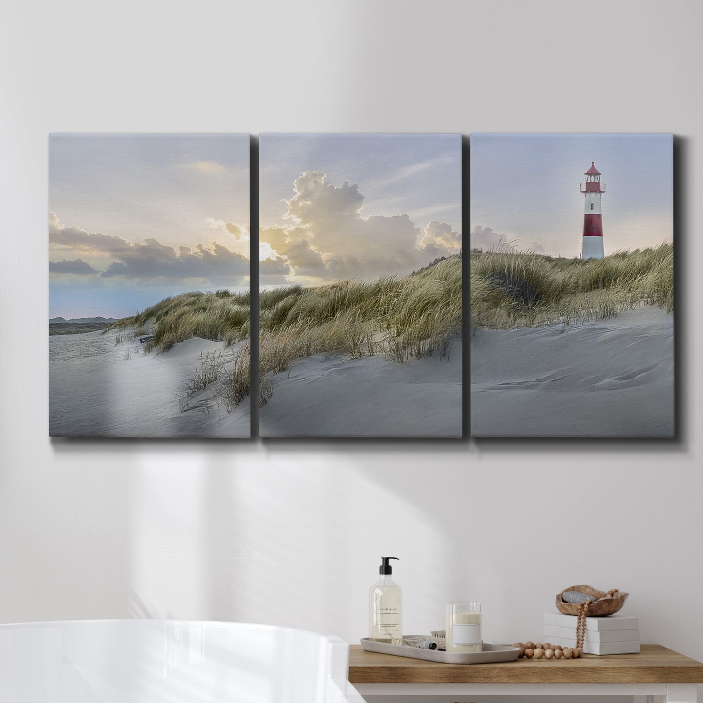 Three-panel canvas wall art featuring guardian boat along shoreline, displayed in a bathroom above a bathtub.