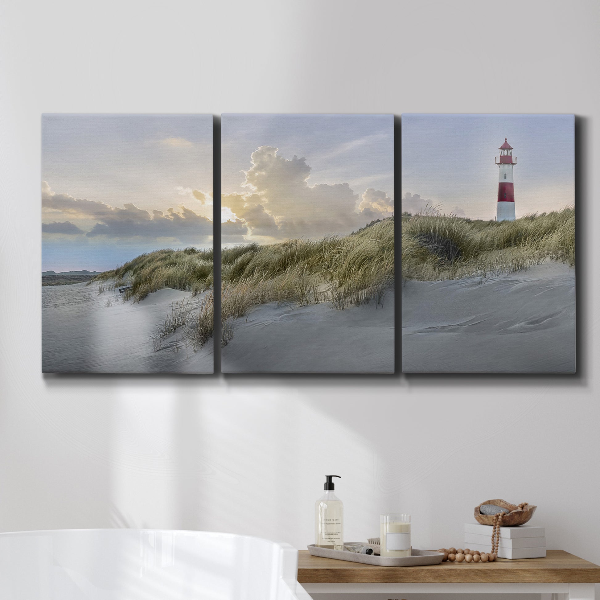 Three-panel canvas wall art featuring guardian boat along shoreline, displayed in a bathroom above a bathtub.