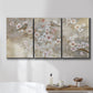Three-panel canvas wall art featuring early spring blossoms in soft tones, displayed in a bathroom above a bathtub.
