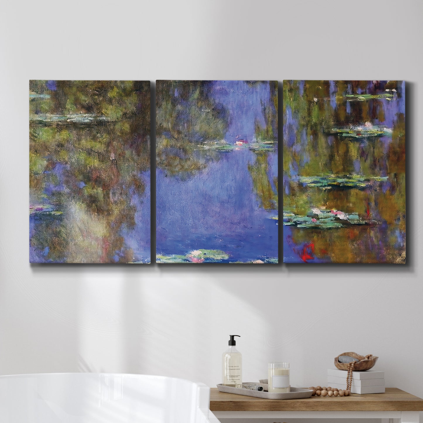 Three-panel canvas wall art featuring blue and purple water lily pond, displayed in a bathroom above a bathtub.