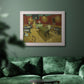 Impressionist interior of a night café by Vincent van Gogh in an ornate weathered white frame displayed in a dark-toned interior setting.
