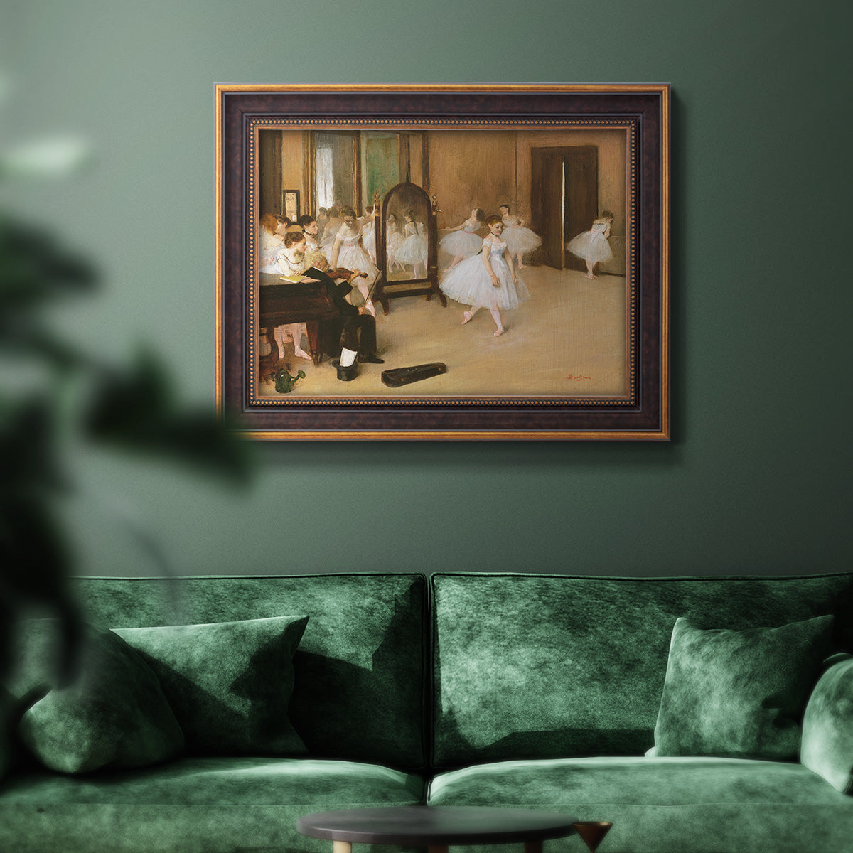 Impressionist dance class interior scene by Edgar Degas in an ornate bronzed mahogany wood frame displayed in a dark-toned interior setting.
