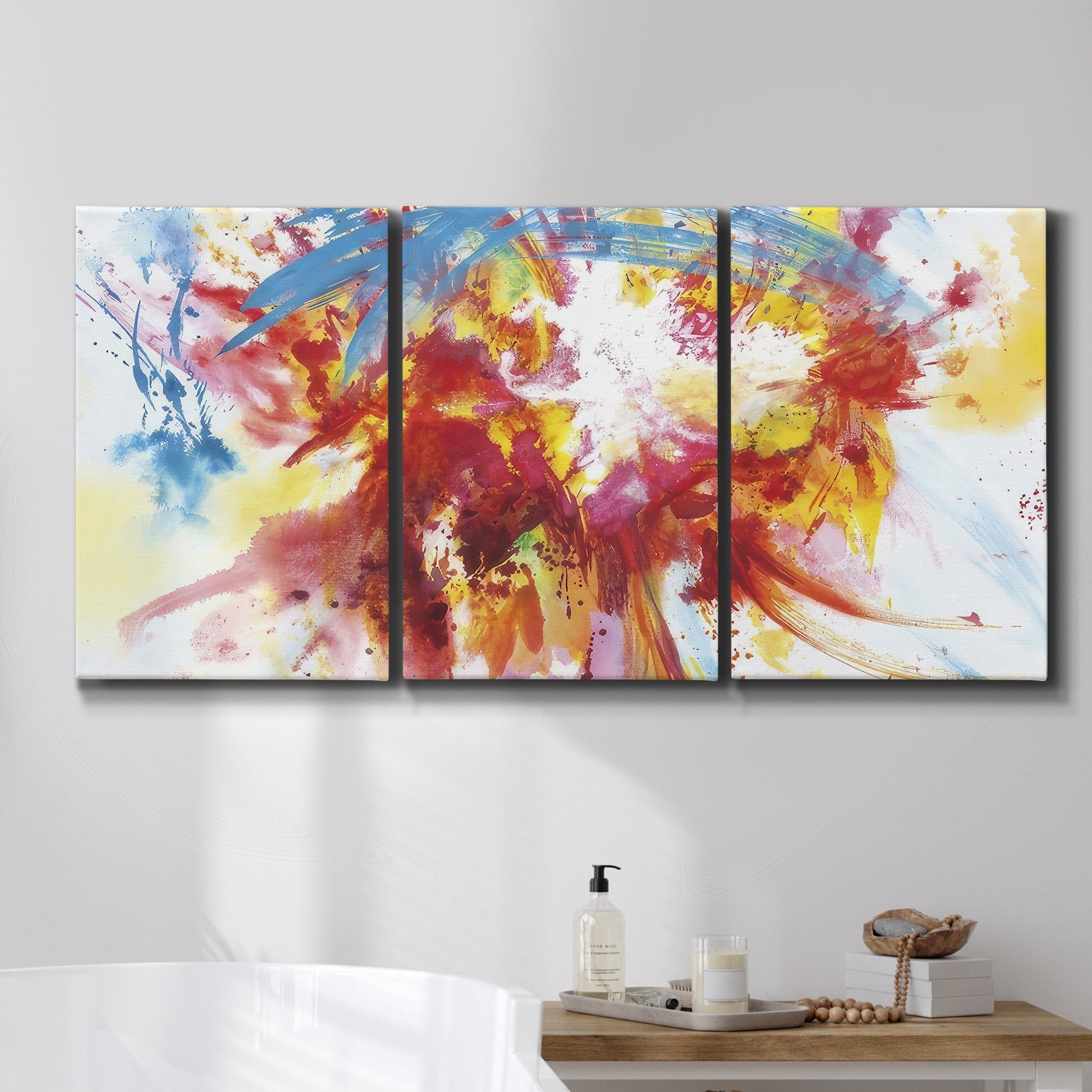 Three-panel canvas wall art featuring bright abstract summer palette, displayed in a bathroom above a bathtub.