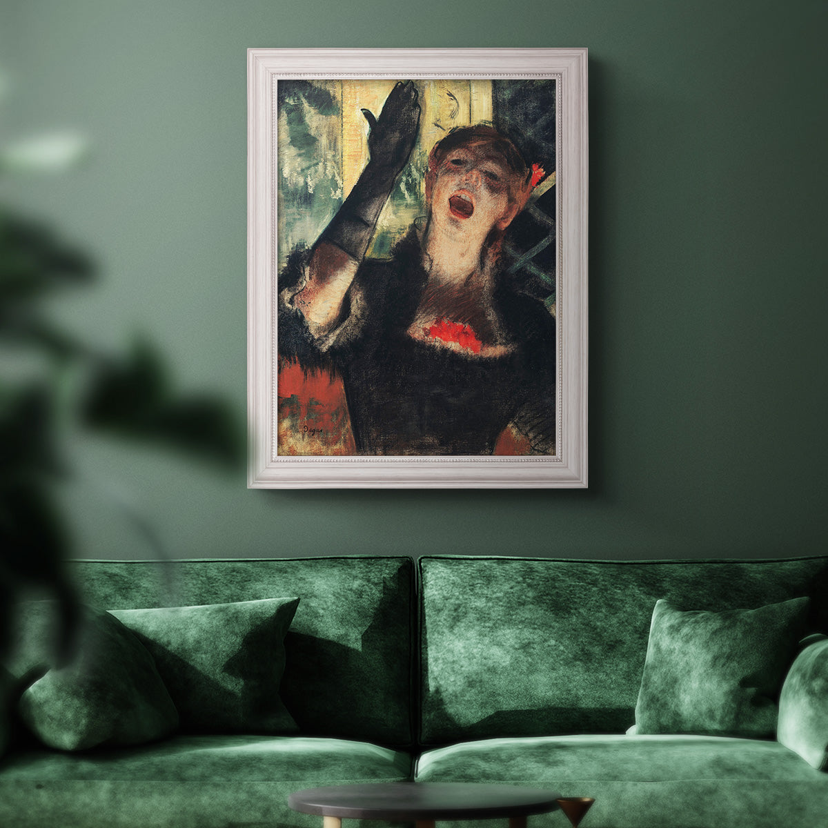 Impressionist portrait of a café singer by Edgar Degas in an ornate weathered white frame displayed in a dark-toned interior setting.
