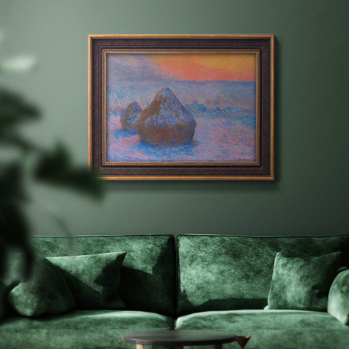 Impressionist haystack scene at sunset by Claude Monet in an ornate bronzed mahogany wood frame displayed in a dark-toned interior setting.