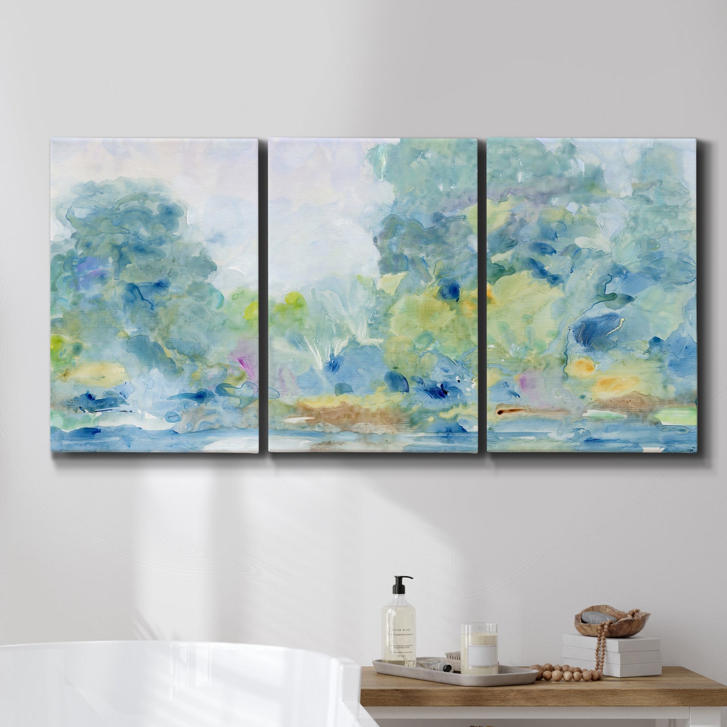 Three-panel canvas wall art featuring quiet abstract morning landscape, displayed in a bathroom above a bathtub.