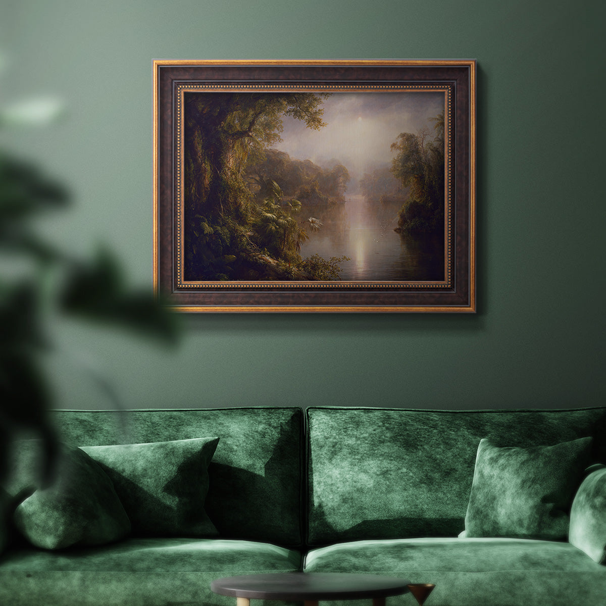 Luminous romantic landscape painting by Frederic Edwin Church in an ornate bronzed mahogany wood frame displayed in a dark-toned interior setting.
