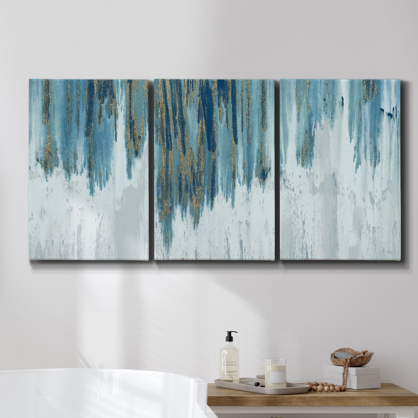 Three-panel canvas wall art featuring wide pastoral valley landscape, displayed in a bathroom above a bathtub.