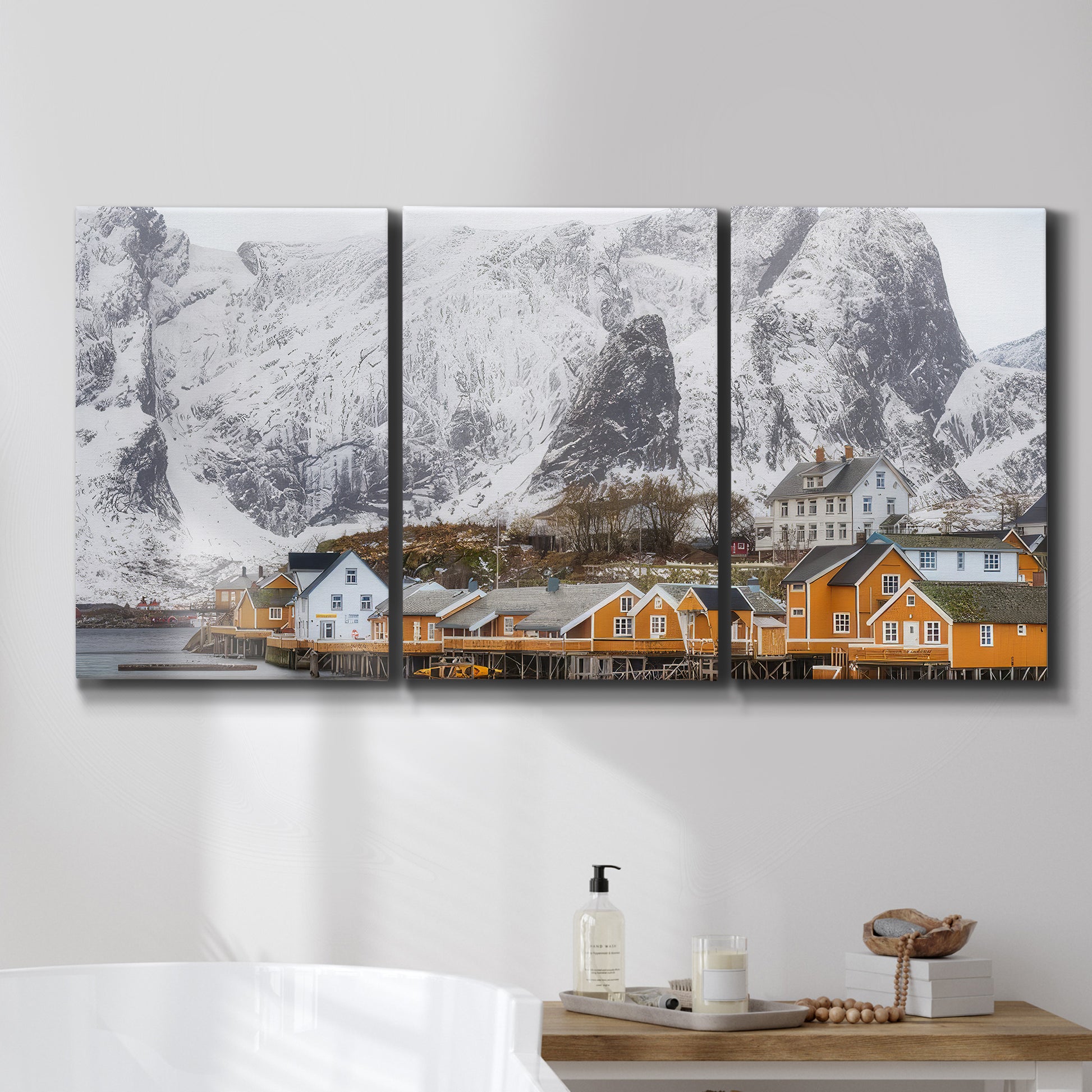 Three-panel canvas wall art featuring winter village street photography, displayed in a bathroom above a bathtub.