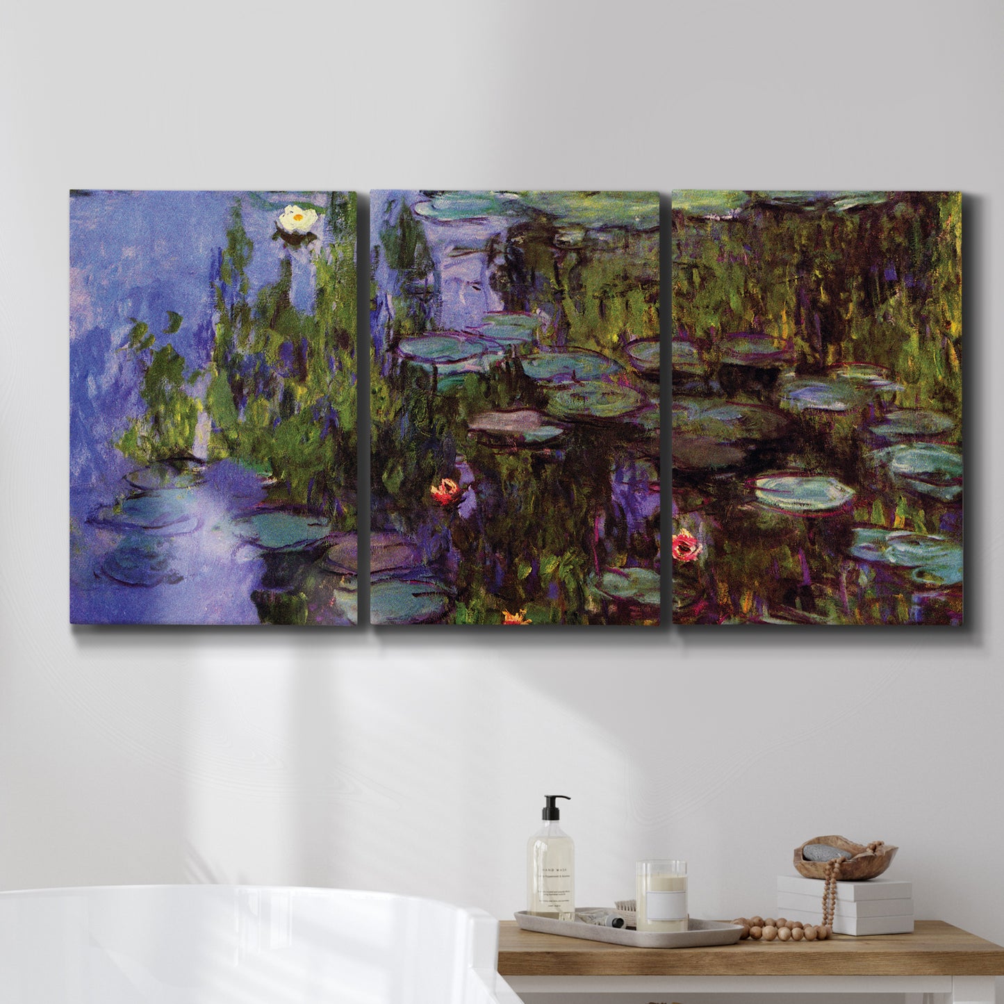 Three-panel canvas wall art featuring water lilies on calm pond, displayed in a bathroom above a bathtub.