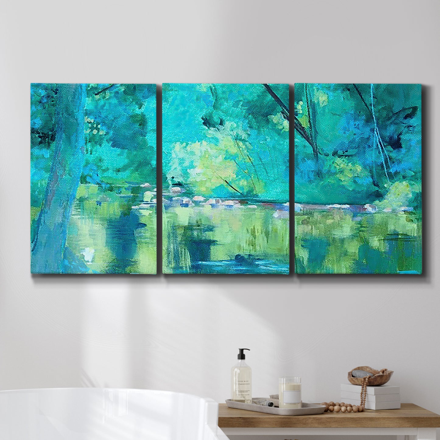 Three-panel canvas wall art featuring abstract river composition with movement, displayed in a bathroom above a bathtub.