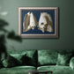 Vintage conch shell illustration on navy background in an ornate vintage silver frame displayed in a dark-toned interior setting.