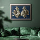 Vintage nautical conch shell artwork on navy background in an ornate vintage silver frame displayed in a dark-toned interior setting.