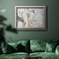 White peony close-up photography in an ornate vintage silver frame displayed in a dark-toned interior setting.