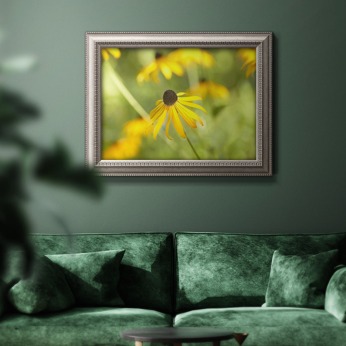 Contemporary black-eyed Susan flower photography in an ornate vintage silver frame displayed in a dark-toned interior setting.