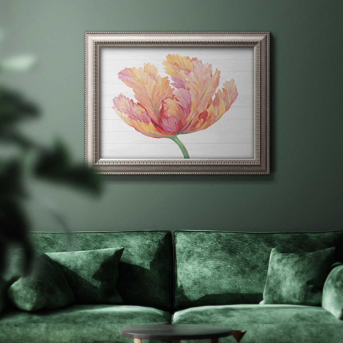Modern minimalist pink floral artwork in an ornate vintage silver frame displayed in a dark-toned interior setting.
