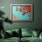 Red autumn leaves against a blue sky in an ornate vintage silver frame displayed in a dark-toned interior setting.
