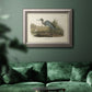 Antique blue heron bird illustration by John James Audubon in an ornate vintage silver frame displayed in a dark-toned interior setting.