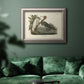 Antique reddish egret bird illustration by John James Audubon in an ornate vintage silver frame displayed in a dark-toned interior setting.