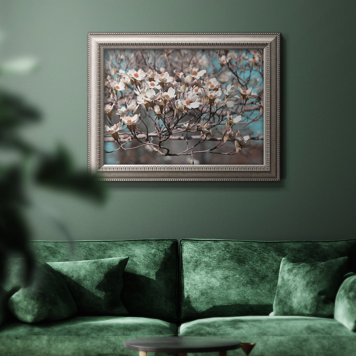 Modern spring dogwood flower photograph in an ornate vintage silver frame displayed in a dark-toned interior setting.