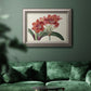 Vintage amaryllis botanical illustration in an ornate vintage silver frame displayed in a dark-toned interior setting.