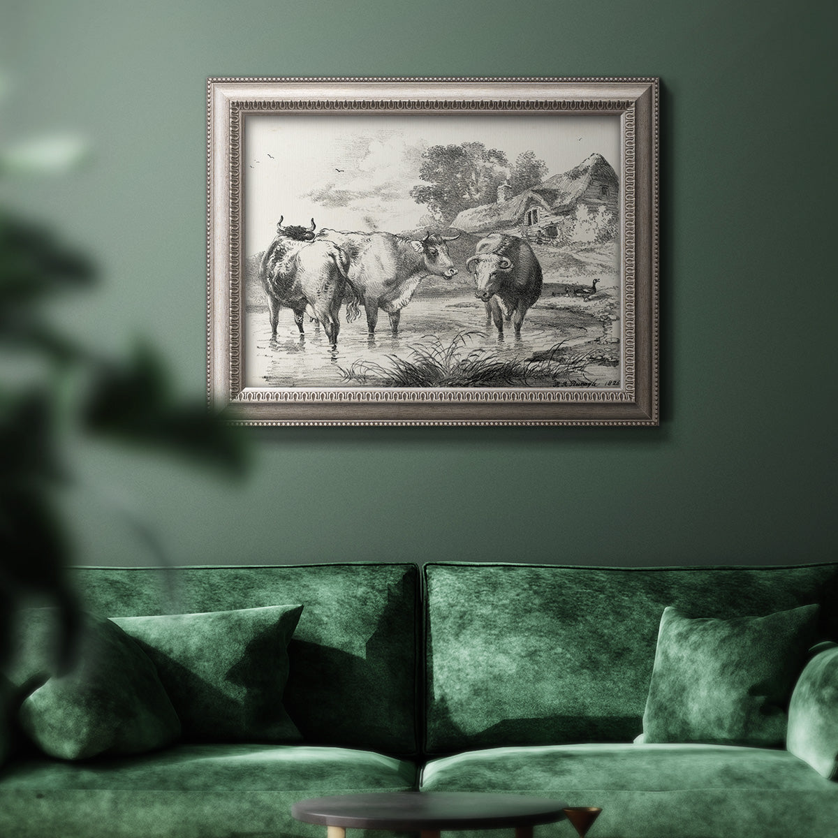 Classical rural landscape artwork by Nicolas Berchem in an ornate vintage silver frame displayed in a dark-toned interior setting.