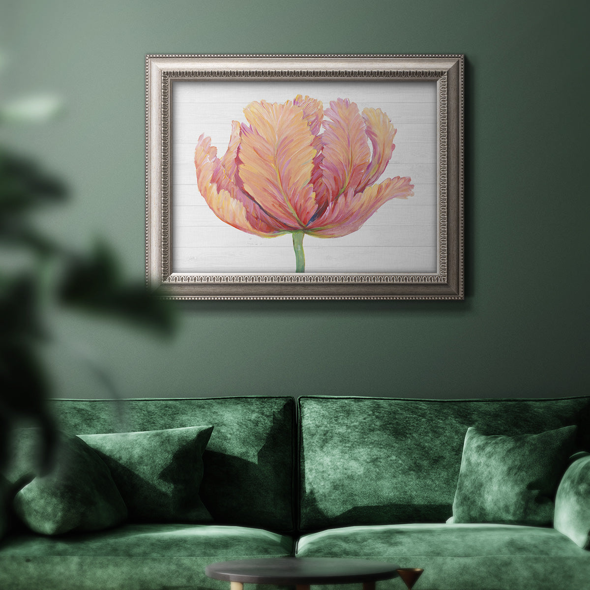 Minimalist pink flower abstract artwork in an ornate vintage silver frame displayed in a dark-toned interior setting.