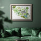 Contemporary abstract succulent botanical watercolor in an ornate vintage silver frame displayed in a dark-toned interior setting.