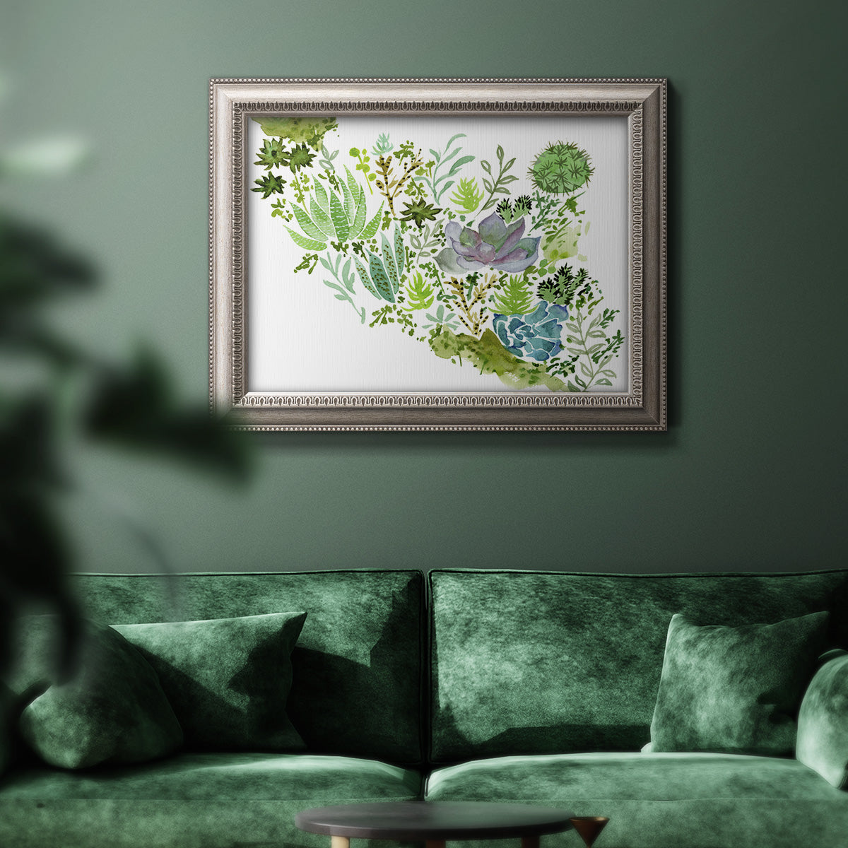 Contemporary abstract succulent botanical watercolor in an ornate vintage silver frame displayed in a dark-toned interior setting.